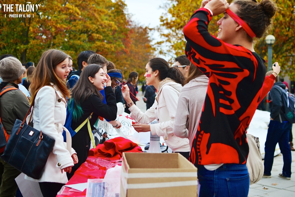 Students prepare for the march with red squares and bar-code face paints.