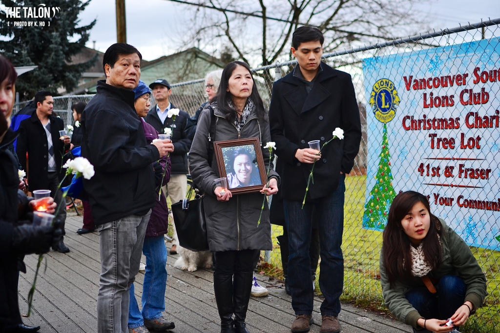 Phuong's sister holds a framed photograph of him